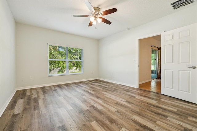 185 Hamlet Loop, Davenport, FL 33837 - empty room with a ceiling fan and wood finished floors
