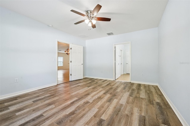 185 Hamlet Loop, Davenport, FL 33837 - unfurnished bedroom featuring light wood-style floors and ceiling fan