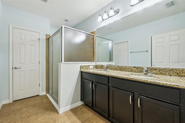 185 Hamlet Loop, Davenport, FL 33837 - bathroom with double vanity, a shower stall, and tile patterned flooring