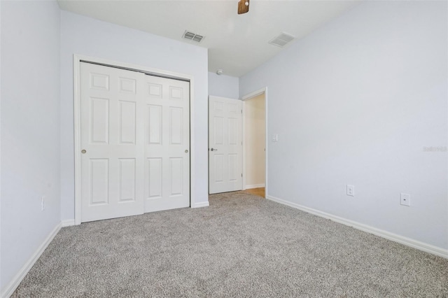 185 Hamlet Loop, Davenport, FL 33837 - unfurnished bedroom with carpet, a closet, and a ceiling fan
