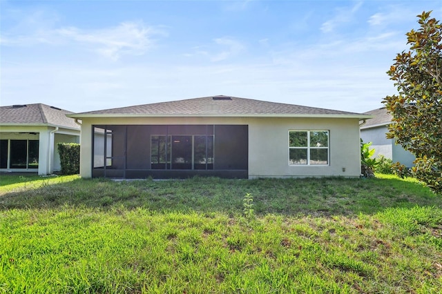 185 Hamlet Loop, Davenport, FL 33837 - rear view of house featuring a sunroom, a lawn, and stucco siding