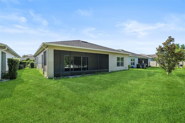 185 Hamlet Loop, Davenport, FL 33837 - back of property featuring a lawn, a sunroom, and stucco siding