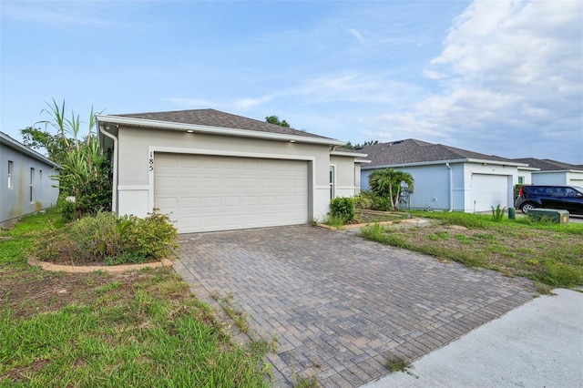 185 Hamlet Loop, Davenport, FL 33837 - view of front of property with stucco siding and decorative driveway