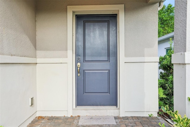 185 Hamlet Loop, Davenport, FL 33837 - doorway to property featuring stucco siding
