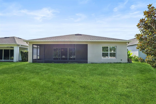 185 Hamlet Loop, Davenport, FL 33837 - back of house featuring a sunroom, a lawn, and stucco siding