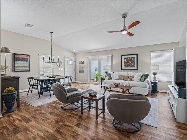 6301 Whittle Ct, The Villages, FL 32163 - living area featuring lofted ceiling, ceiling fan, a chandelier, wood finished floors, and baseboards