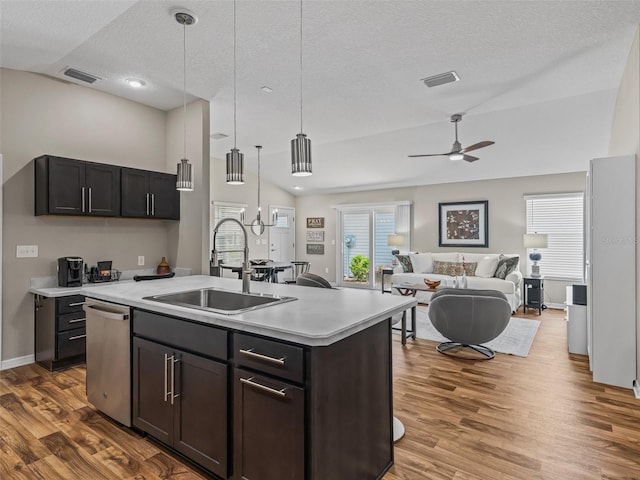 6301 Whittle Ct, The Villages, FL 32163 - kitchen featuring a sink, stainless steel dishwasher, lofted ceiling, light countertops, and wood finished floors