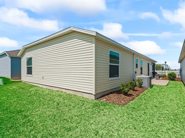 6301 Whittle Ct, The Villages, FL 32163 - view of side of home with central air condition unit and a patio