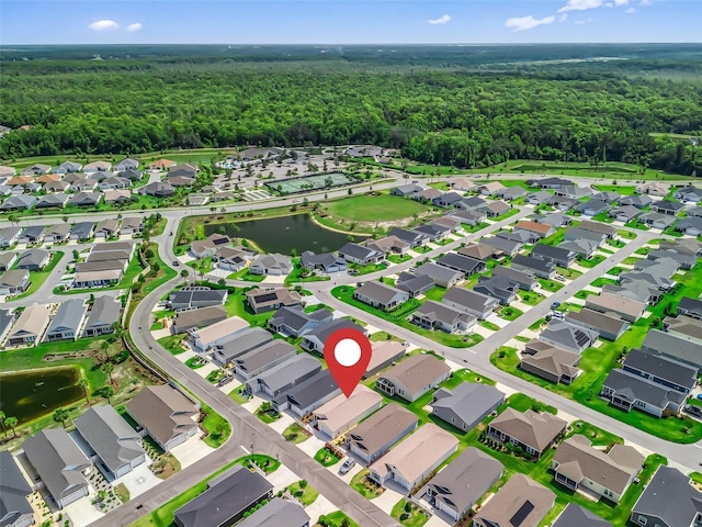 6301 Whittle Ct, The Villages, FL 32163 - aerial overview of property's location featuring a forest, nearby suburban area, and a nearby body of water