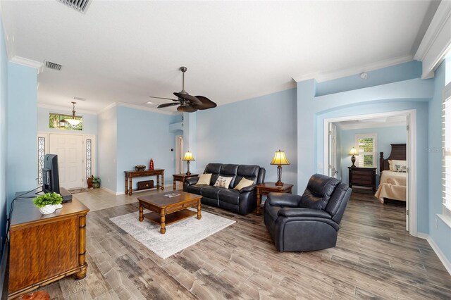 1910 Quiet Oak Ct, The Villages, FL 32162 - living room featuring wood finished floors, a ceiling fan, crown molding, and baseboards