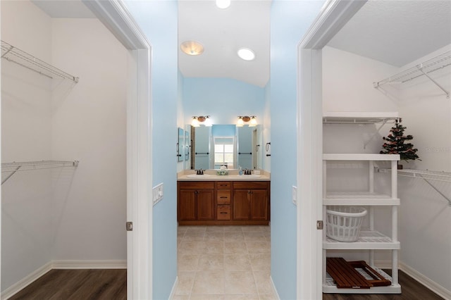 1910 Quiet Oak Ct, The Villages, FL 32162 - walk in closet featuring a sink and vaulted ceiling