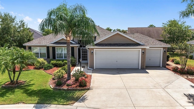 1910 Quiet Oak Ct, The Villages, FL 32162 - view of front of property with an attached garage, roof with shingles, driveway, and a front lawn