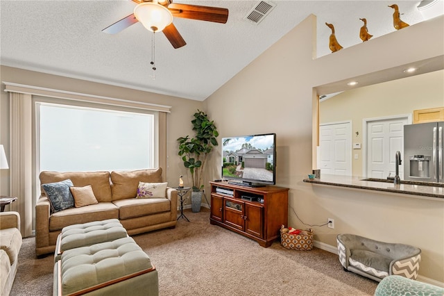 4083 Capland Ave, Clermont, FL 34711 - living area featuring light carpet, a ceiling fan, baseboards, high vaulted ceiling, and a textured ceiling