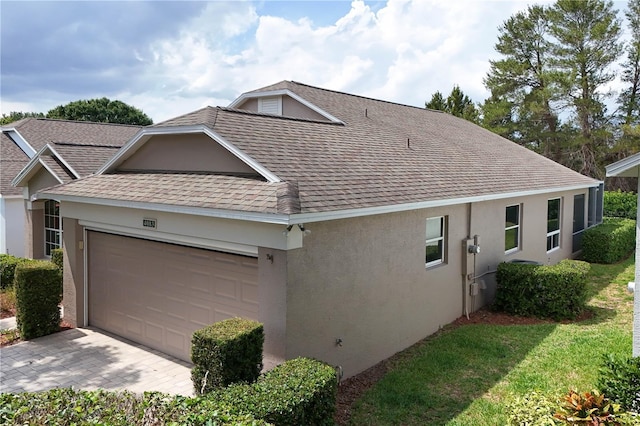 4083 Capland Ave, Clermont, FL 34711 - view of home's exterior featuring roof with shingles, stucco siding, a garage, and driveway