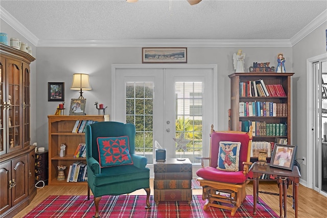 2785 Privada Dr, The Villages, FL 32162 - living area with french doors, wood finished floors, a textured ceiling, crown molding, and ceiling fan