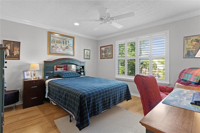 2785 Privada Dr, The Villages, FL 32162 - bedroom with ornamental molding, light wood-type flooring, a textured ceiling, ceiling fan, and baseboards