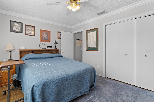 2785 Privada Dr, The Villages, FL 32162 - bedroom with a textured ceiling, ornamental molding, a closet, a ceiling fan, and carpet flooring