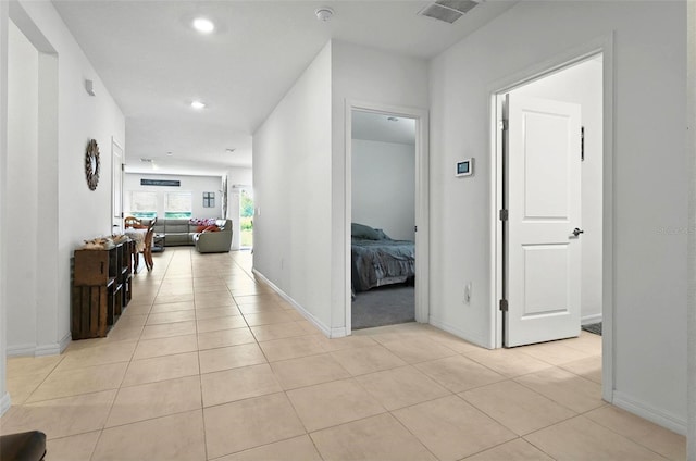 33960 Sky Blossom Cir, Leesburg, FL 34788 - corridor with light tile patterned flooring, recessed lighting, and baseboards
