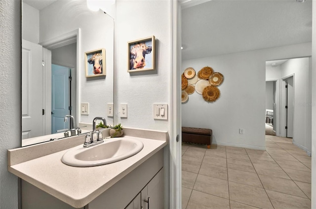 33960 Sky Blossom Cir, Leesburg, FL 34788 - bathroom featuring vanity, tile patterned floors, and baseboards