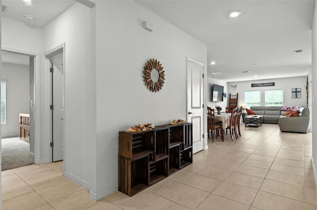 33960 Sky Blossom Cir, Leesburg, FL 34788 - hallway featuring light tile patterned floors, recessed lighting, and baseboards