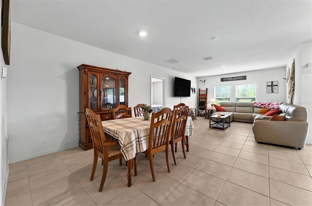 33960 Sky Blossom Cir, Leesburg, FL 34788 - dining space featuring light tile patterned flooring