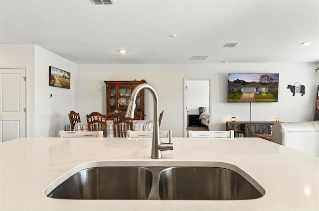 33960 Sky Blossom Cir, Leesburg, FL 34788 - kitchen featuring a sink, open floor plan, light countertops, and recessed lighting
