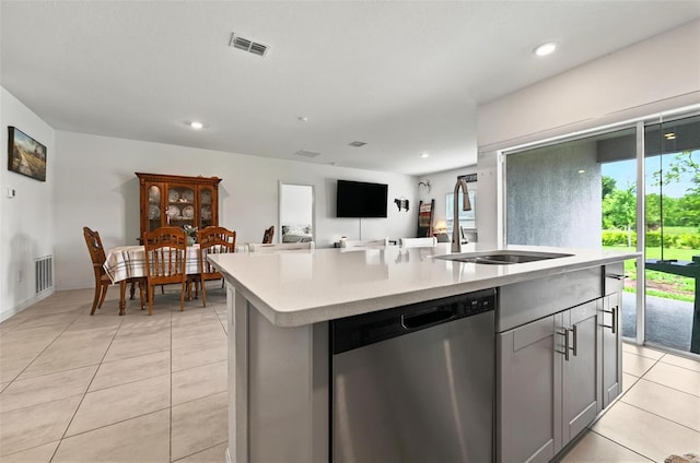 33960 Sky Blossom Cir, Leesburg, FL 34788 - kitchen featuring dishwasher, a sink, light countertops, an island with sink, and light tile patterned flooring