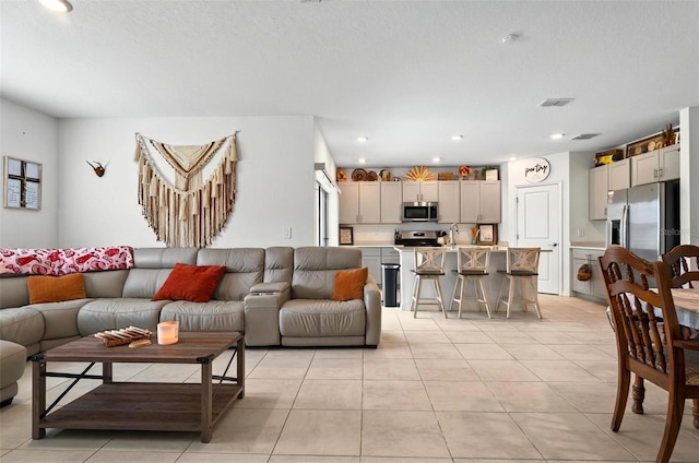 33960 Sky Blossom Cir, Leesburg, FL 34788 - living room featuring light tile patterned floors and recessed lighting