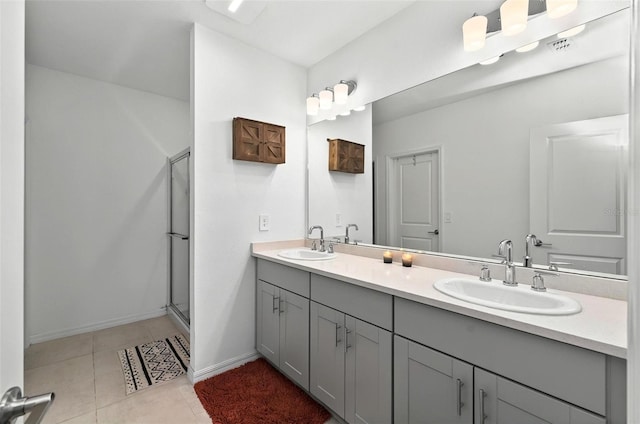 33960 Sky Blossom Cir, Leesburg, FL 34788 - full bathroom with double vanity, a shower with shower door, tile patterned floors, and baseboards