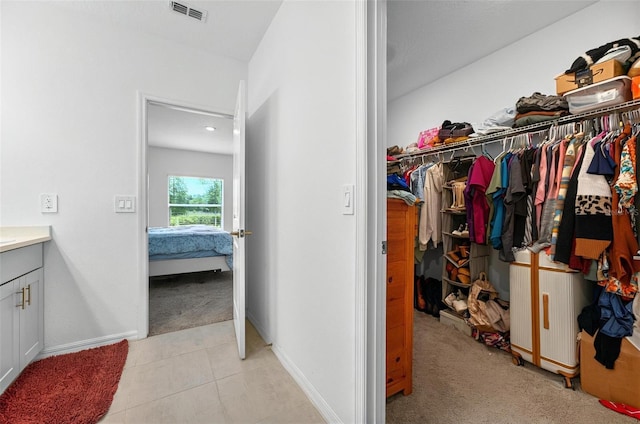 33960 Sky Blossom Cir, Leesburg, FL 34788 - walk in closet featuring light colored carpet