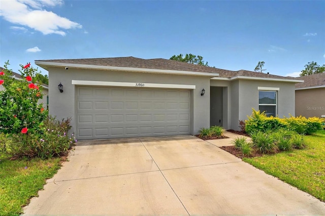 33960 Sky Blossom Cir, Leesburg, FL 34788 - view of front facade with a garage, stucco siding, and concrete driveway
