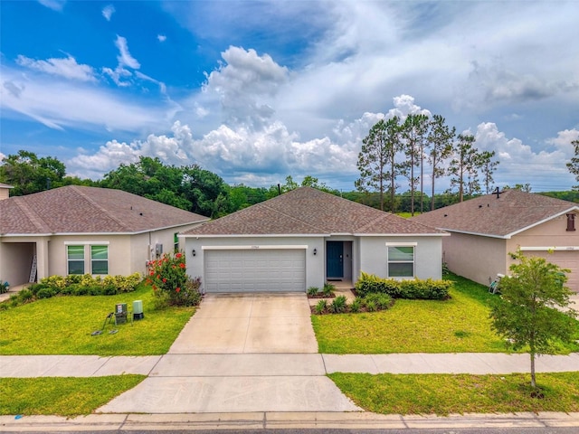 33960 Sky Blossom Cir, Leesburg, FL 34788 - single story home with an attached garage, driveway, a front lawn, stucco siding, and roof with shingles