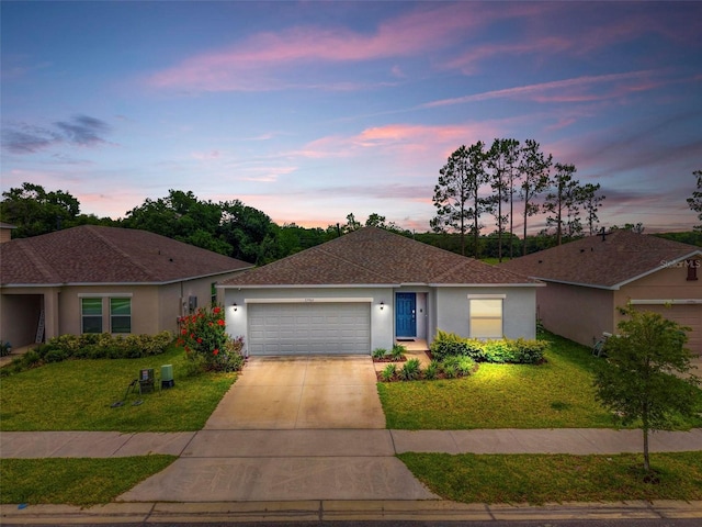 33960 Sky Blossom Cir, Leesburg, FL 34788 - single story home featuring an attached garage, a front lawn, driveway, stucco siding, and a shingled roof