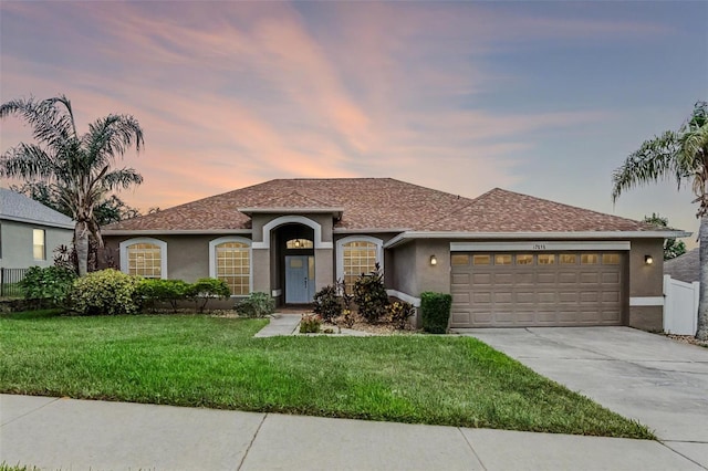 12838 Owasso Ln, Clermont, FL 34711 - view of front of house featuring stucco siding, driveway, a garage, and a shingled roof