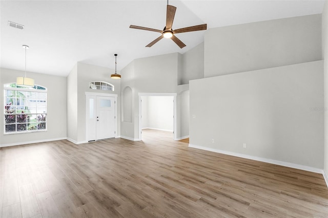 12838 Owasso Ln, Clermont, FL 34711 - unfurnished living room with high vaulted ceiling, ceiling fan, light wood-style flooring, and baseboards