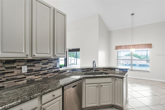 12838 Owasso Ln, Clermont, FL 34711 - kitchen with dishwasher, a sink, a peninsula, tasteful backsplash, and dark stone countertops