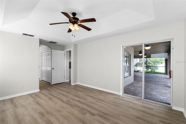 12838 Owasso Ln, Clermont, FL 34711 - unfurnished room with ceiling fan, wood finished floors, baseboards, and arched walkways
