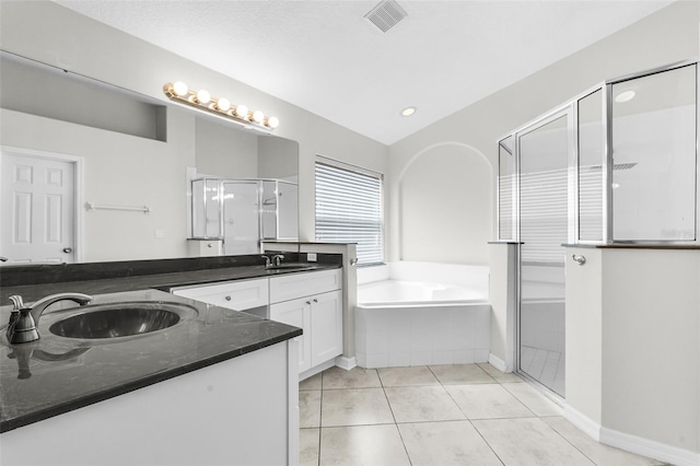 12838 Owasso Ln, Clermont, FL 34711 - bathroom with vanity, a shower stall, a bath, and tile patterned floors