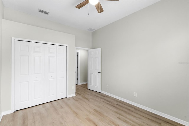 12838 Owasso Ln, Clermont, FL 34711 - unfurnished bedroom featuring light wood-style flooring, a closet, baseboards, and a ceiling fan