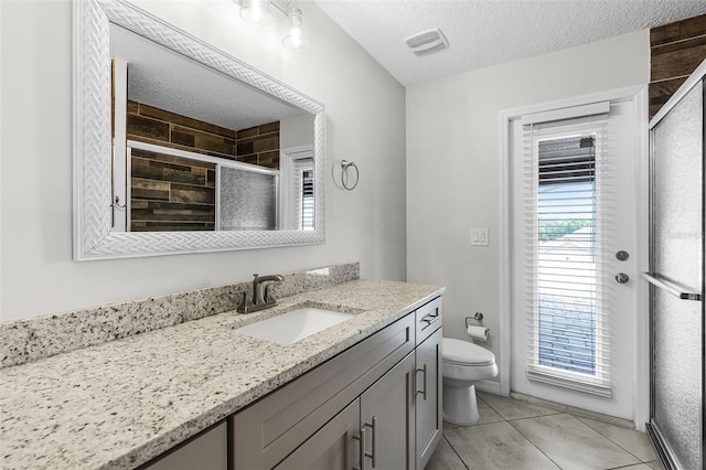 12838 Owasso Ln, Clermont, FL 34711 - full bath featuring vanity, a stall shower, toilet, a textured ceiling, and tile patterned flooring