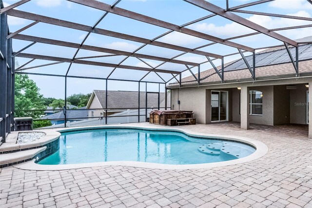 12838 Owasso Ln, Clermont, FL 34711 - outdoor pool with a hot tub, a patio area, and glass enclosure