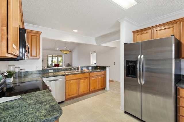 654 Fayette Ct, The Villages, FL 32162 - kitchen featuring appliances with stainless steel finishes, a sink, crown molding, a peninsula, and brown cabinetry