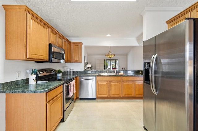 654 Fayette Ct, The Villages, FL 32162 - kitchen featuring appliances with stainless steel finishes, dark countertops, brown cabinets, a sink, and ornamental molding
