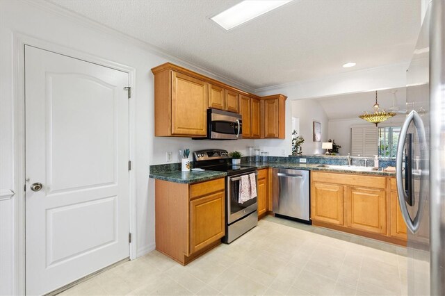 654 Fayette Ct, The Villages, FL 32162 - kitchen with appliances with stainless steel finishes, dark countertops, brown cabinetry, a sink, and crown molding