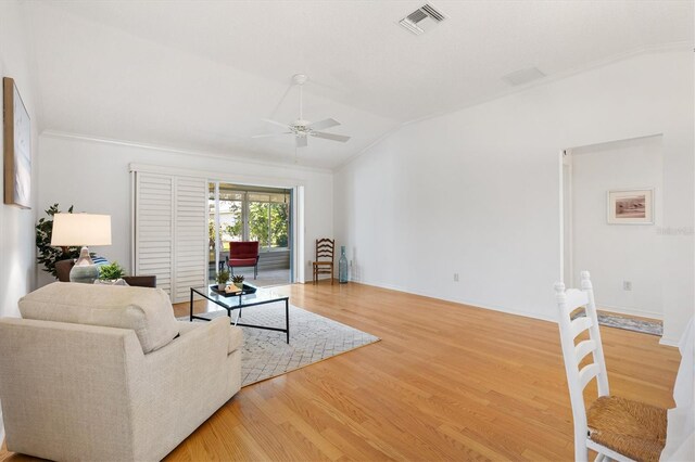654 Fayette Ct, The Villages, FL 32162 - living room featuring a ceiling fan, light wood finished floors, lofted ceiling, crown molding, and baseboards