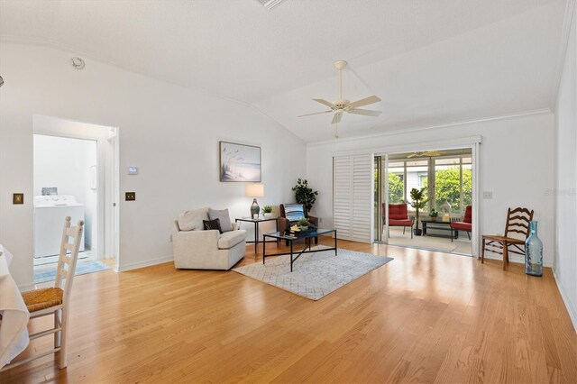 654 Fayette Ct, The Villages, FL 32162 - living area featuring washer / dryer, vaulted ceiling, light wood-type flooring, ceiling fan, and baseboards