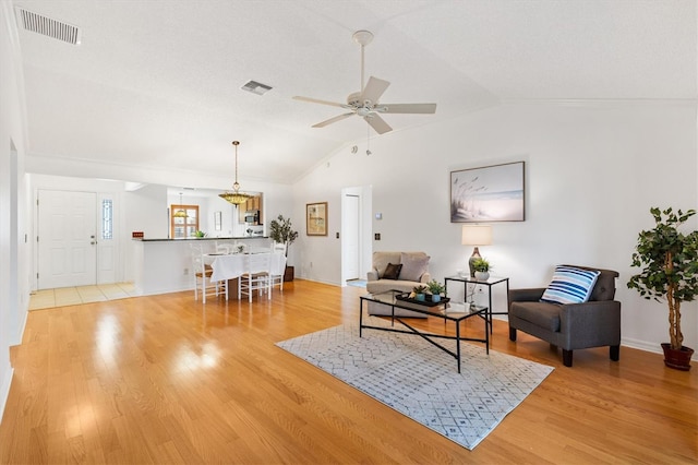 654 Fayette Ct, The Villages, FL 32162 - living area with lofted ceiling, ceiling fan, light wood-style flooring, and baseboards
