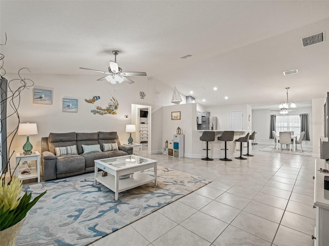 9364 SE 164th Pl, Summerfield, FL 34491 - living area featuring ceiling fan, a chandelier, light tile patterned floors, lofted ceiling, and baseboards