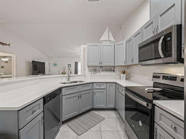 9364 SE 164th Pl, Summerfield, FL 34491 - kitchen with stainless steel appliances, a sink, gray cabinets, light tile patterned floors, and light countertops