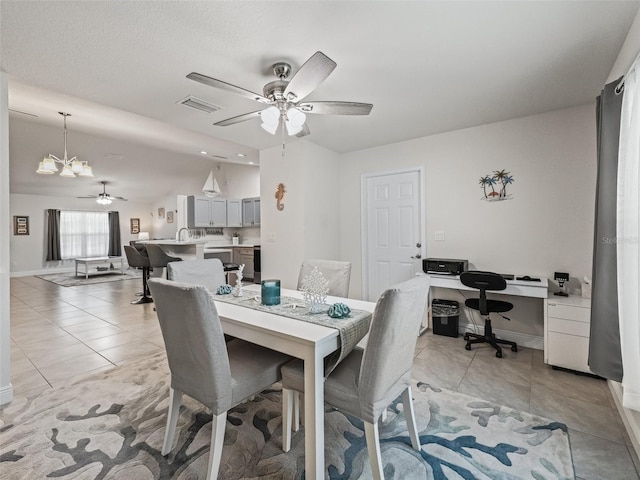 9364 SE 164th Pl, Summerfield, FL 34491 - dining area with ceiling fan, a desk, a chandelier, and light tile patterned flooring